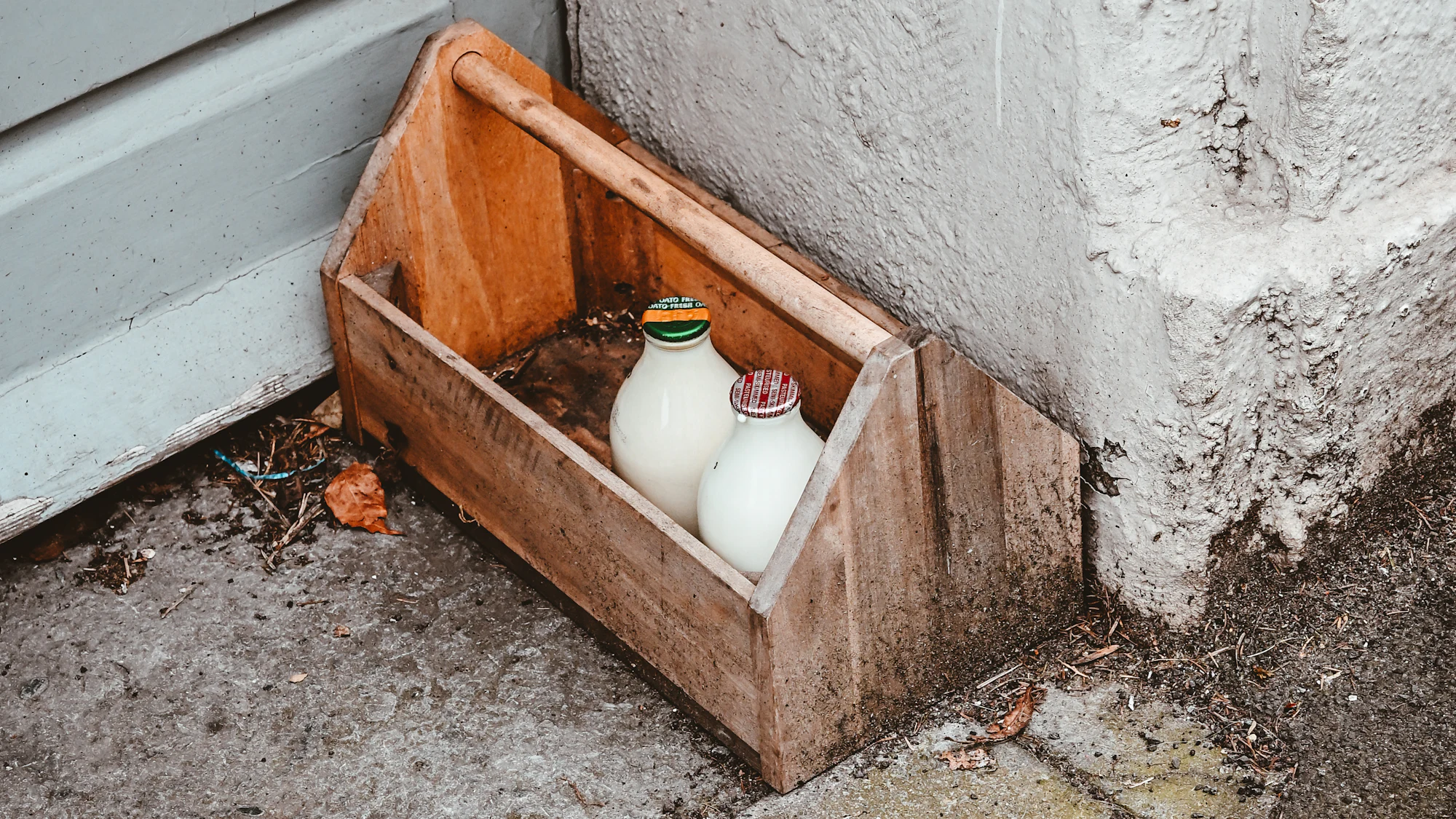 Glass milk bottles in a wooden delivery crate
